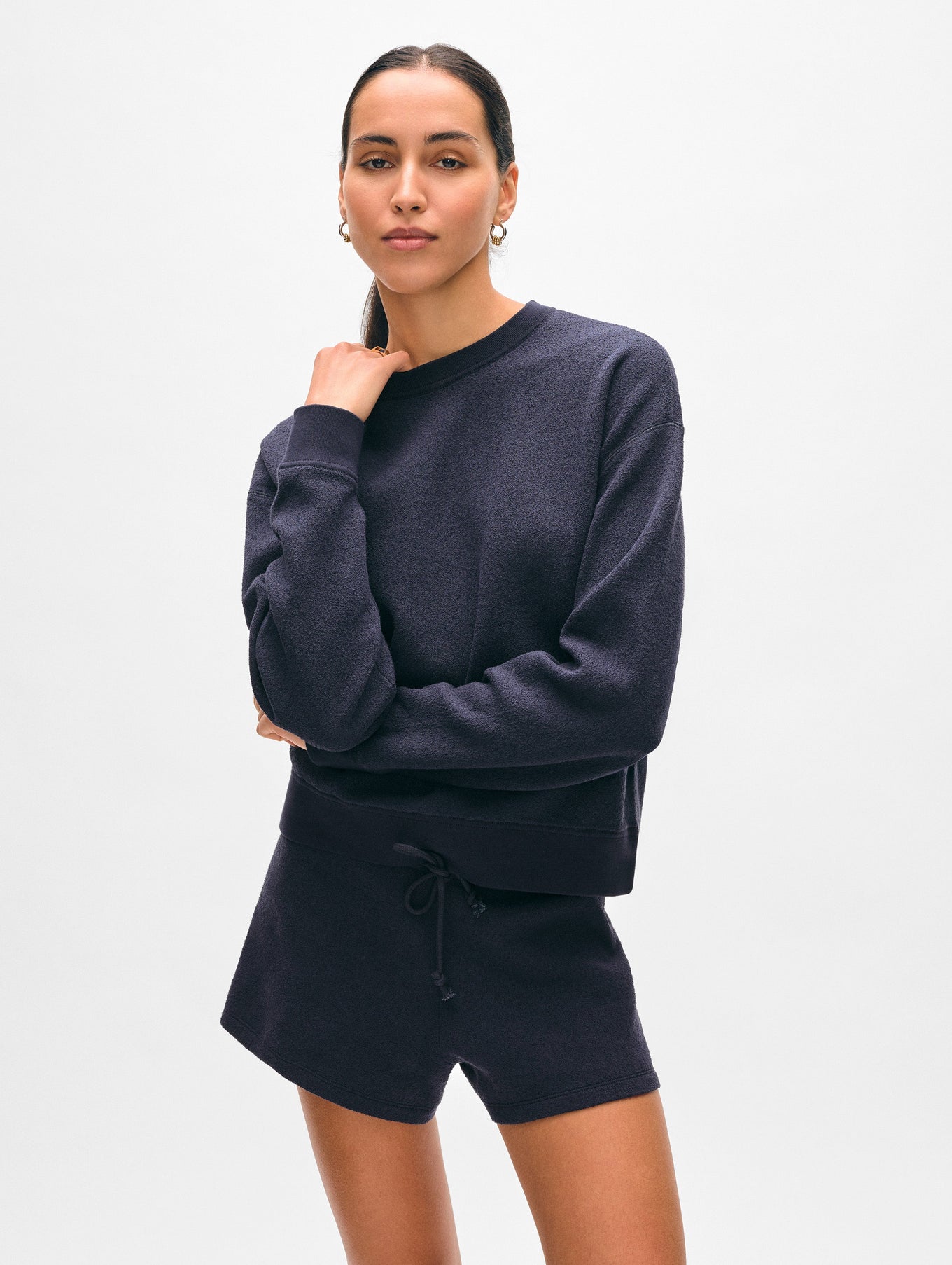 Model wearing navy cotton crewneck sweater.