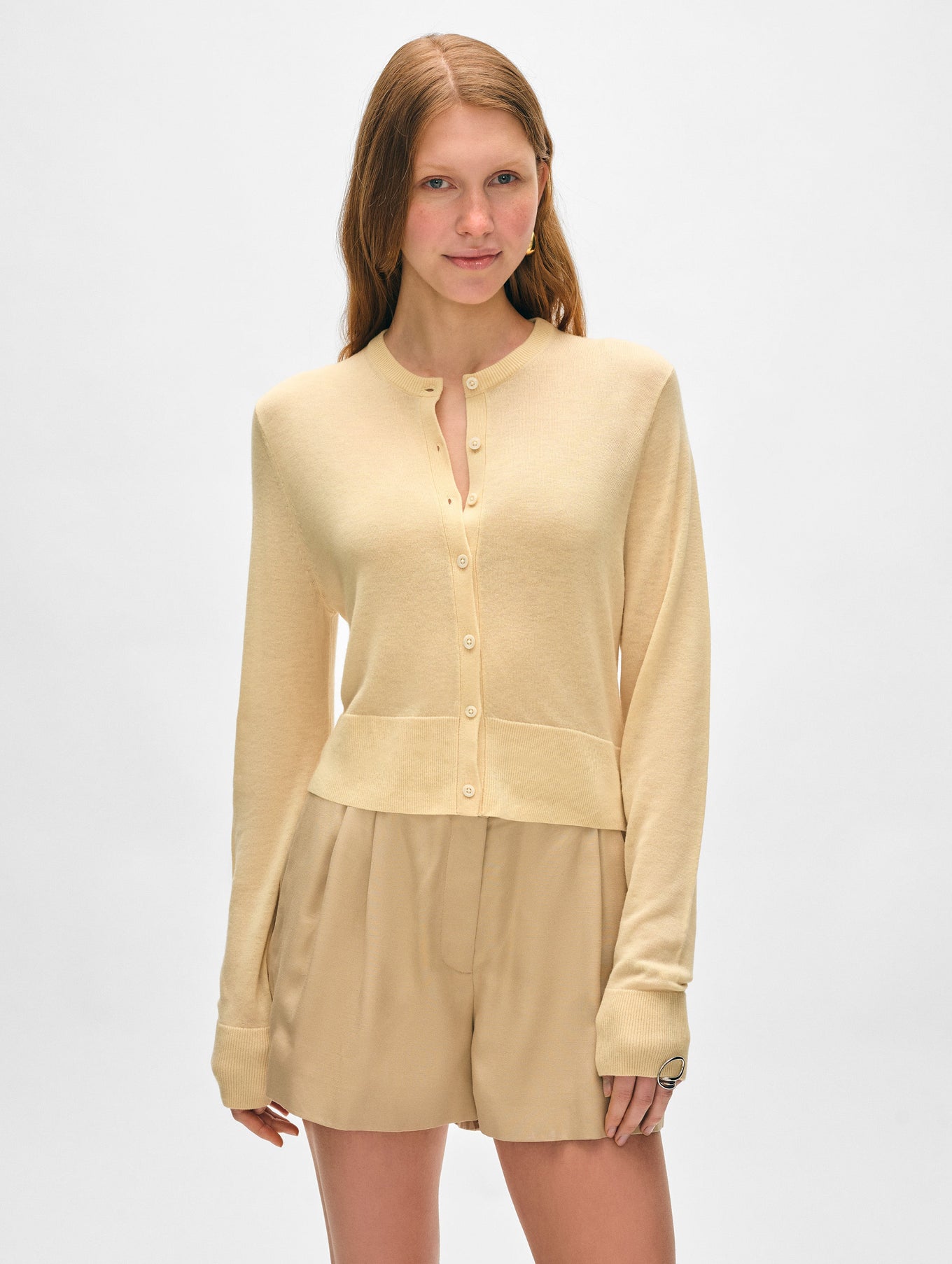 Model wearing butter yellow superfine cashmere button cardigan.