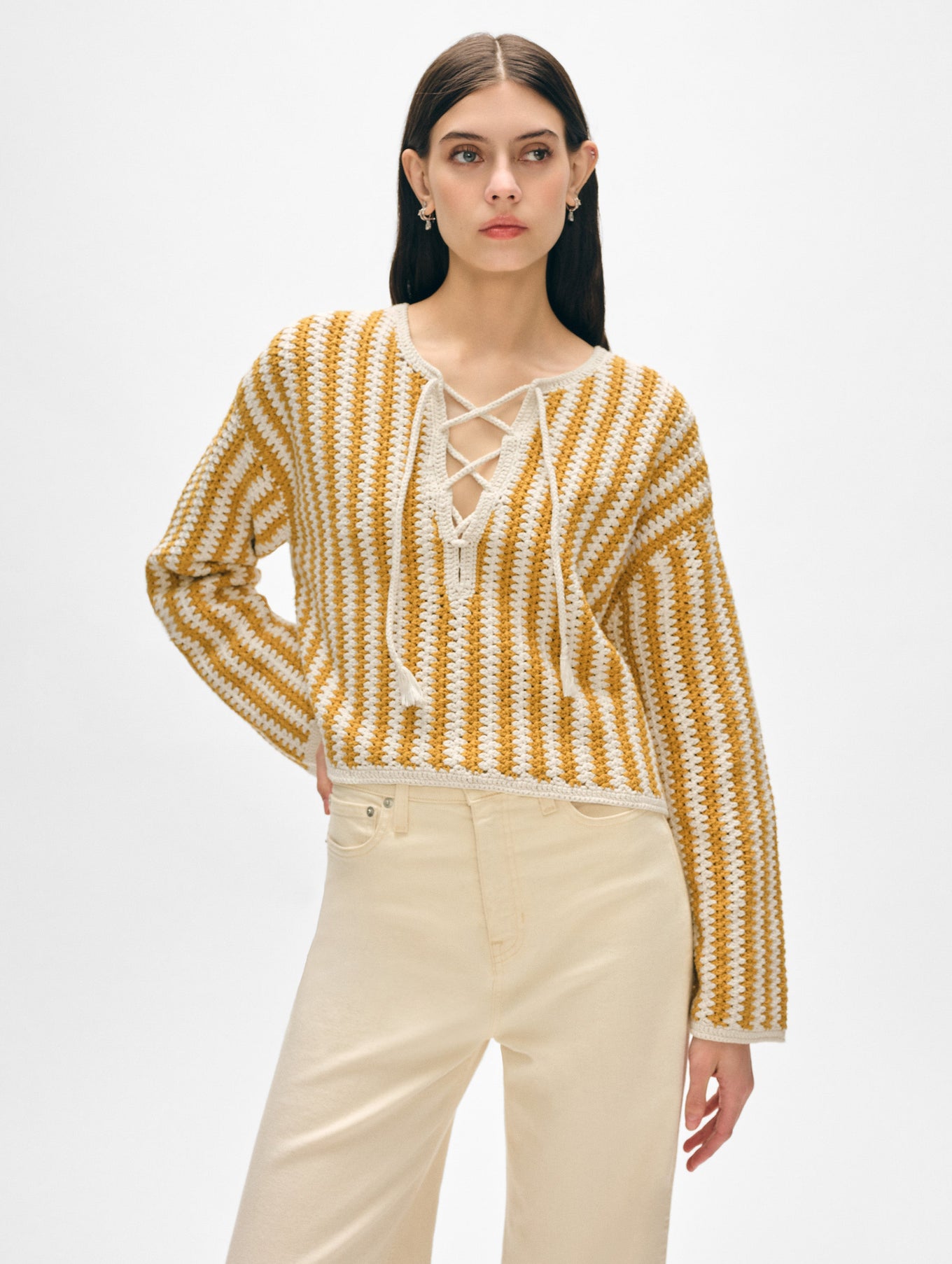 Model wearing yellow and white cotton splitneck sweater.