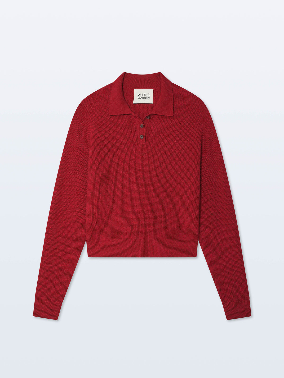 A red long-sleeve knit polo sweater with a cropped hem and three-button placket, displayed flat against a light gray background.