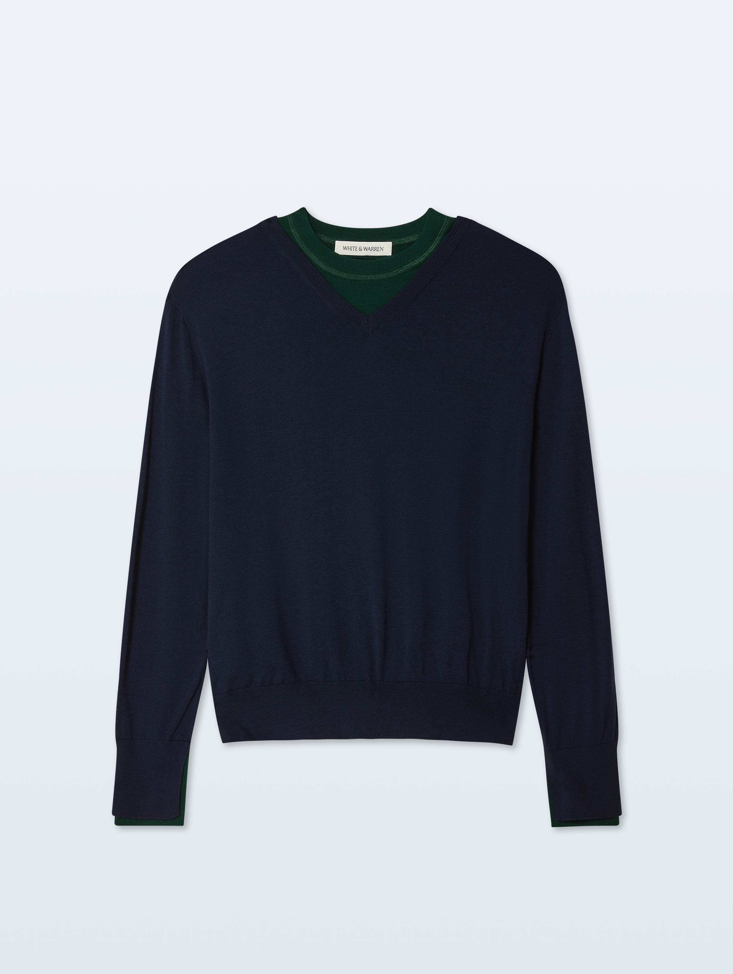 A dark navy blue knit sweater with a contrasting dark green v-neck collar, displayed flat against a light gray background.