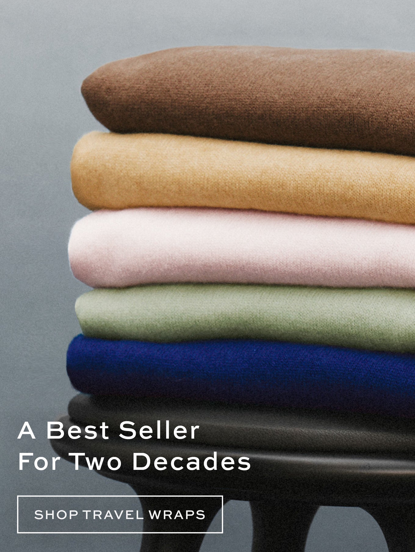 Stack of cashmere Travel Wraps in various colors.