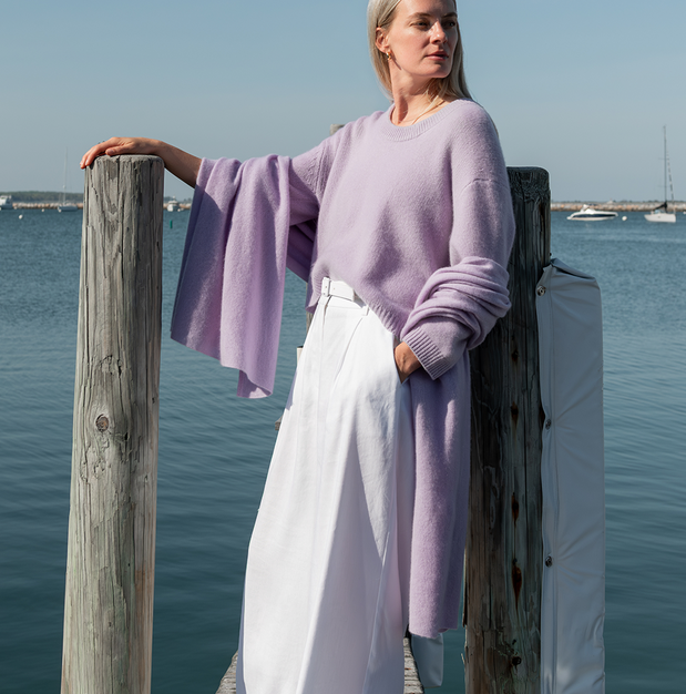 woman wearing cashmere travel wrap standing on a dock